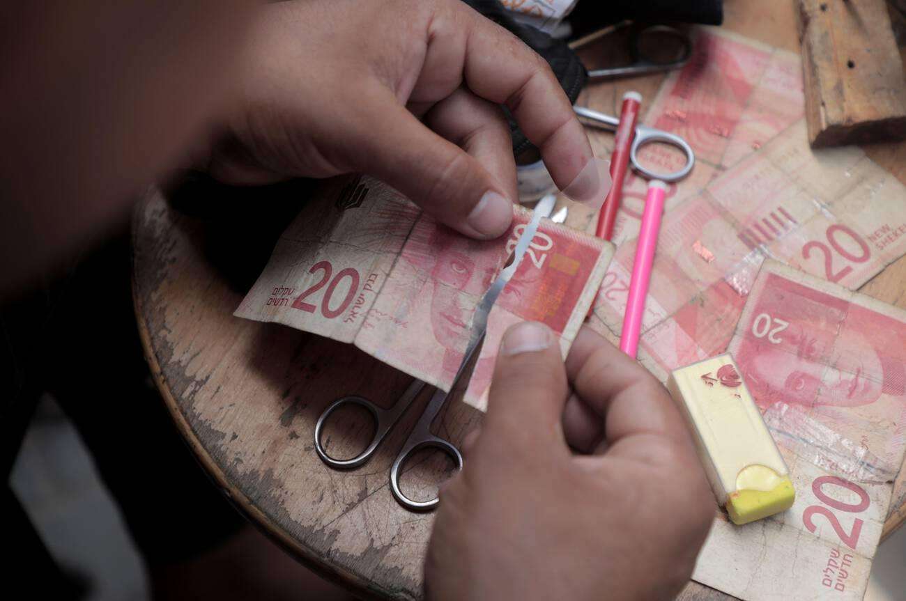 משבר הכסף המזומן בעזה: העמלות מזנקות, והסוחרים מסרבים לשטרות ישנים
